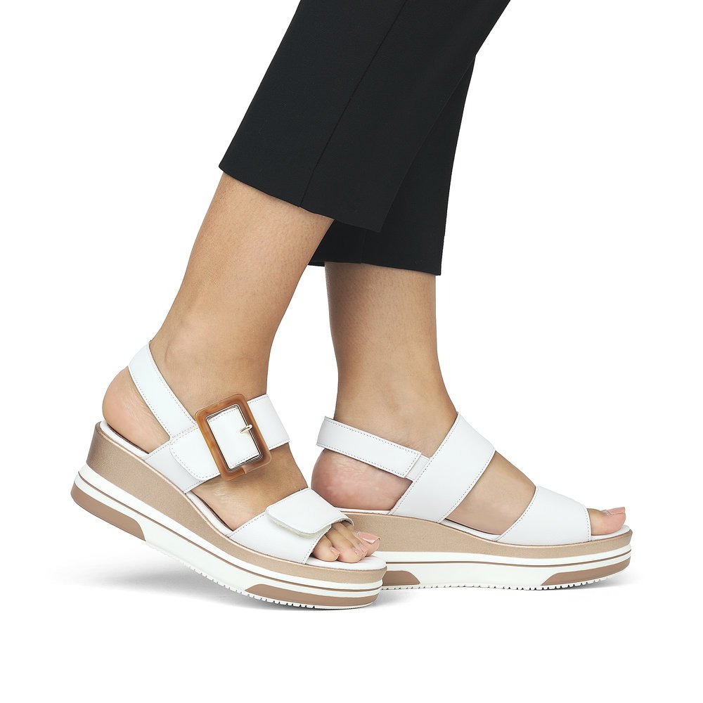 Pure white remonte women´s wedge sandals D1P50-80 with a hook and loop fastener. Shoe on foot.