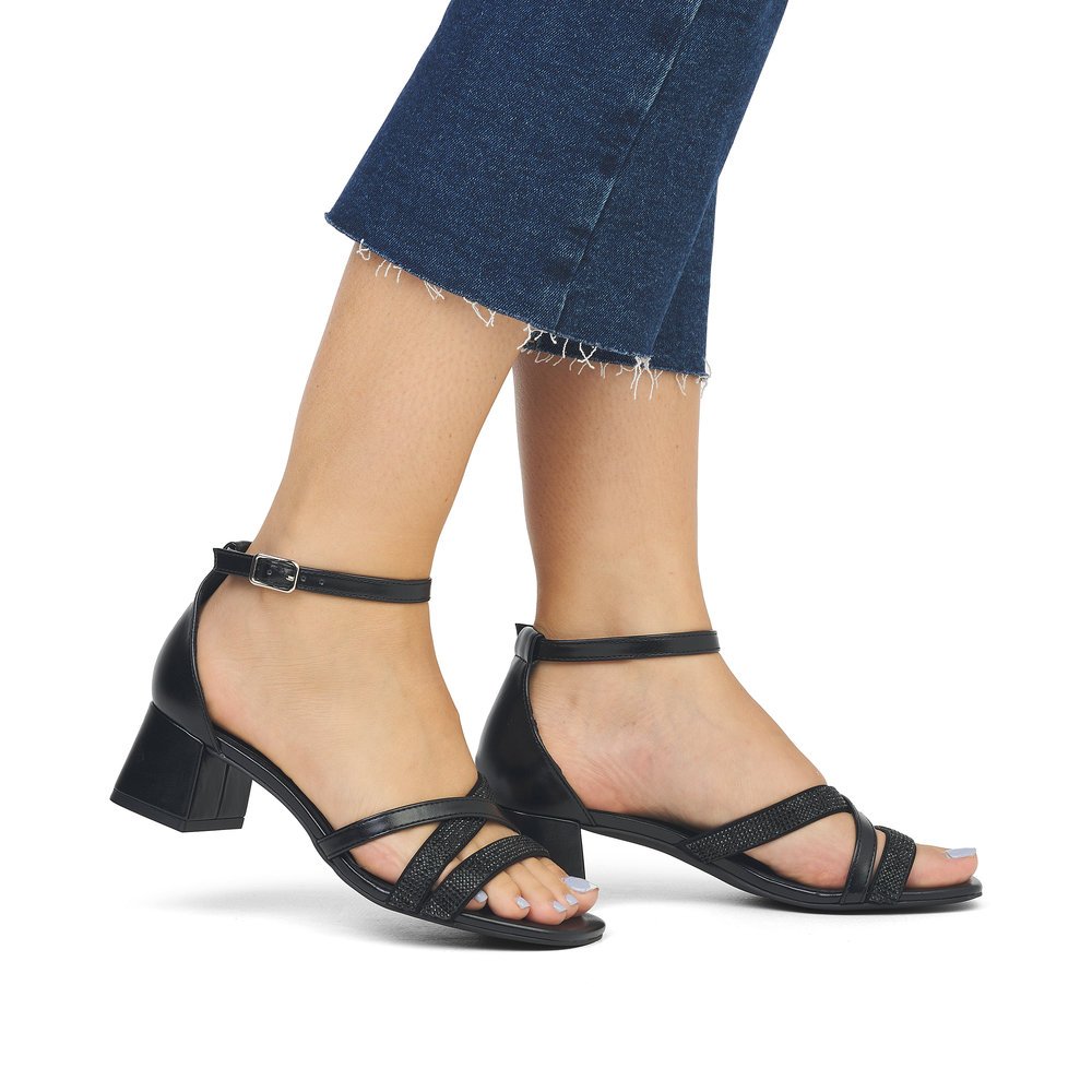 Black vegan remonte women´s strap sandals D1L51-00 with buckle and soft cover sole. Shoe on foot.