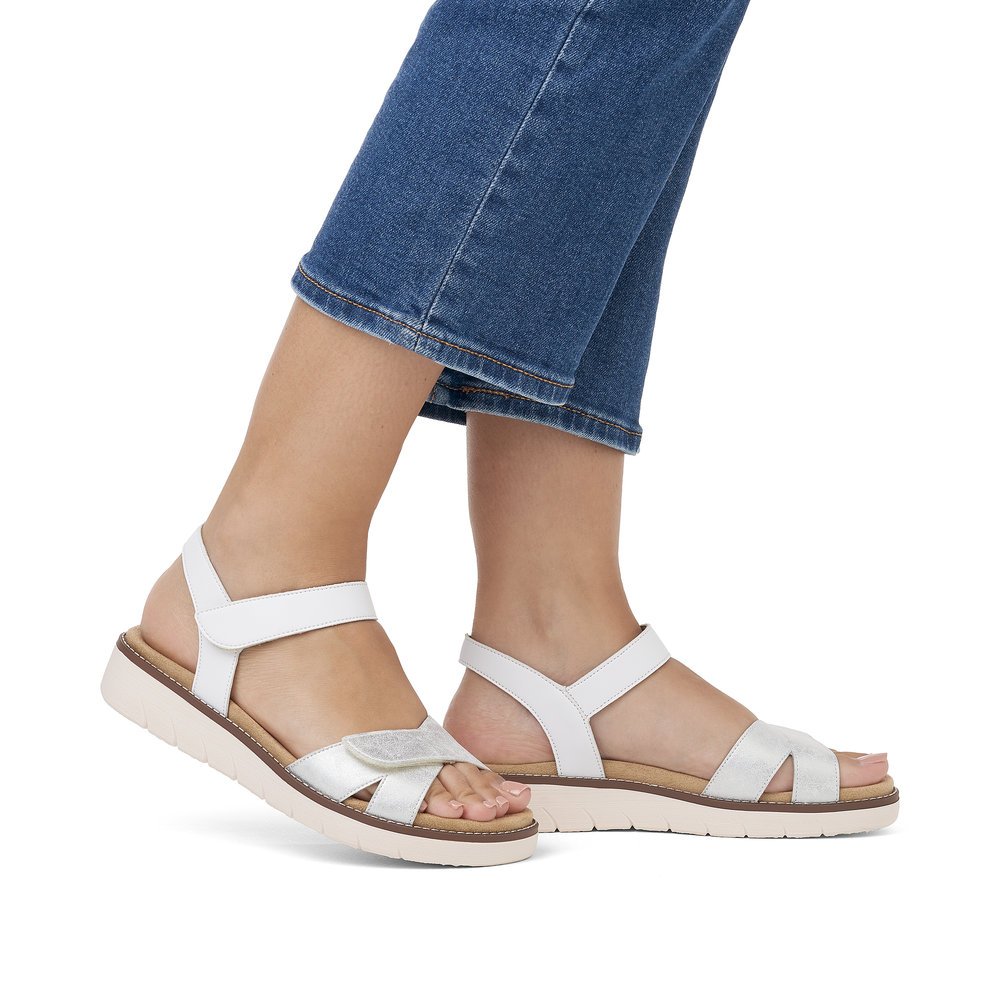 White remonte women´s strap sandals D2049-82 with a hook and loop fastener. Shoe on foot.