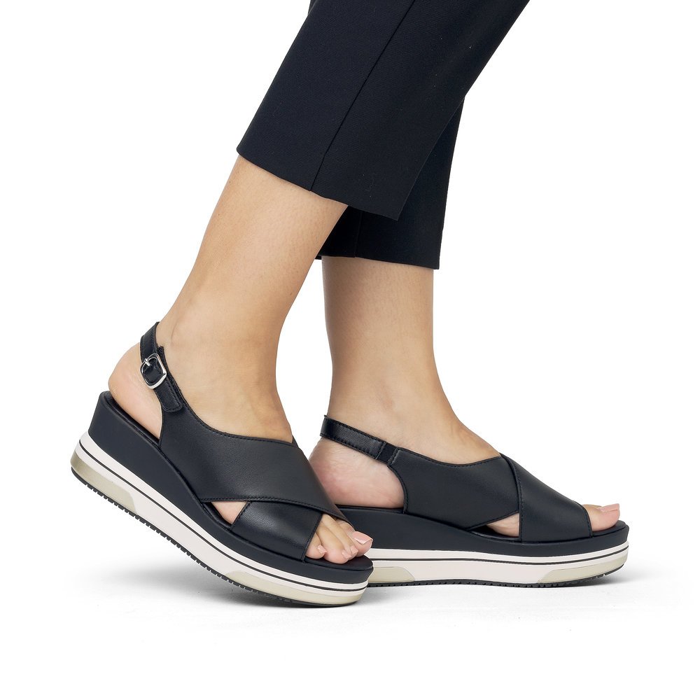 Night black remonte women´s wedge sandals D1P53-00 with a hook and loop fastener. Shoe on foot.