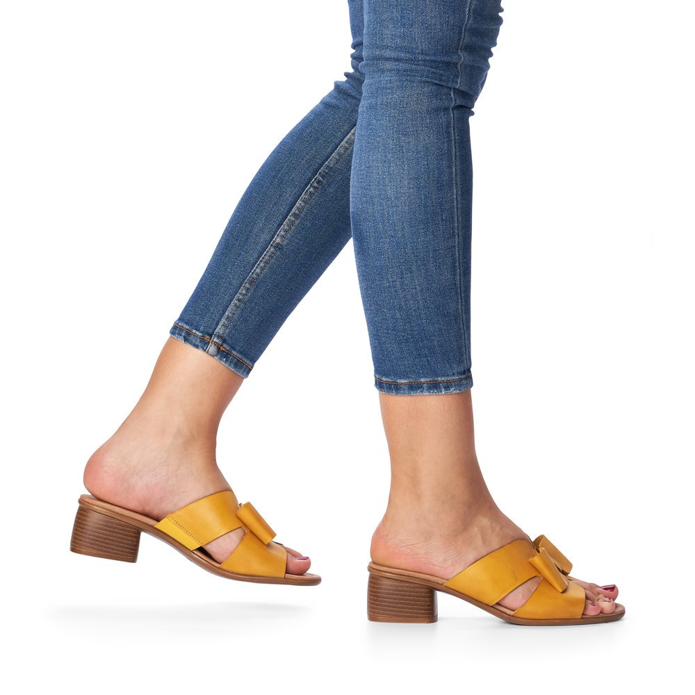 Yellow remonte women´s mules R8759-68 with feminine bow. Shoe on foot.