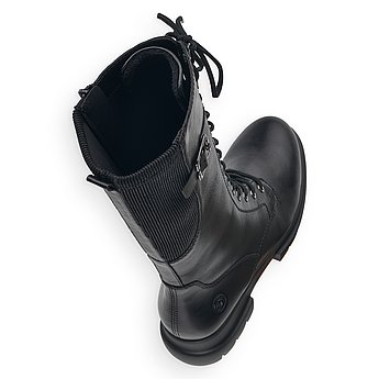 Schwarze Stiefel warm gefüttert aus Glattleder mit Reißverschluss und Schnürung, Stretch-Einsatz im Wadenbereich und Wechselfußbett. Schuhe Innenseite.