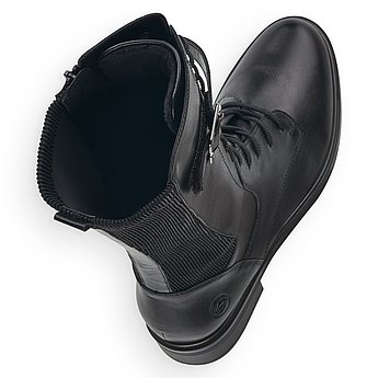 Schwarze Stiefel leicht wärmend aus Glattleder mit Reißverschluss und Schnürung, Stretch-Einsatz im Wadenbereich und Wechselfußbett. Schuhe Innenseite.