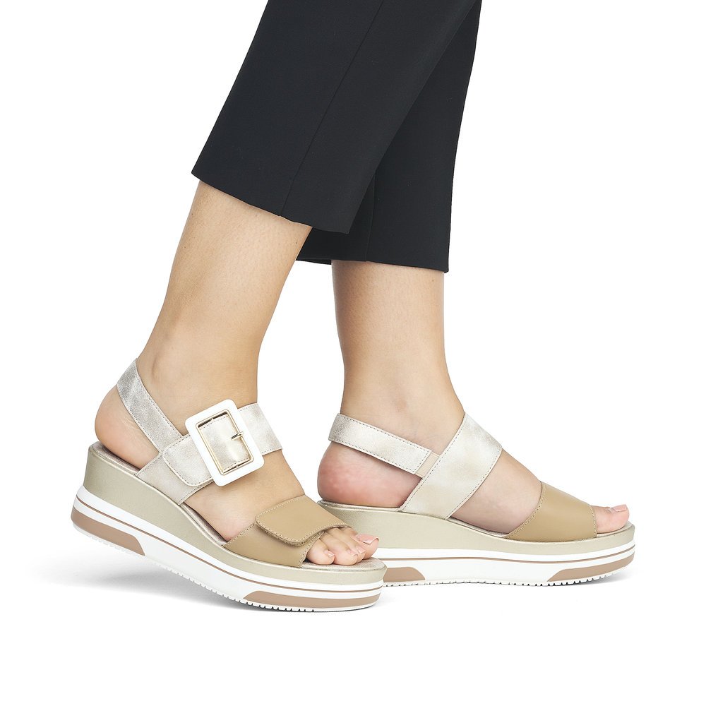 Beige remonte women´s wedge sandals D1P50-90 with hook and loop fastener. Shoe on foot.