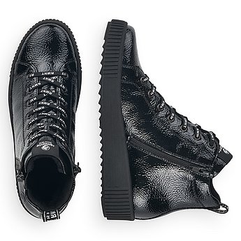 Schwarze Stiefeletten warm gefüttert aus Kunstlack mit Reißverschluss und Schnürung und Wechselfußbett. Schuhe Innenseite.