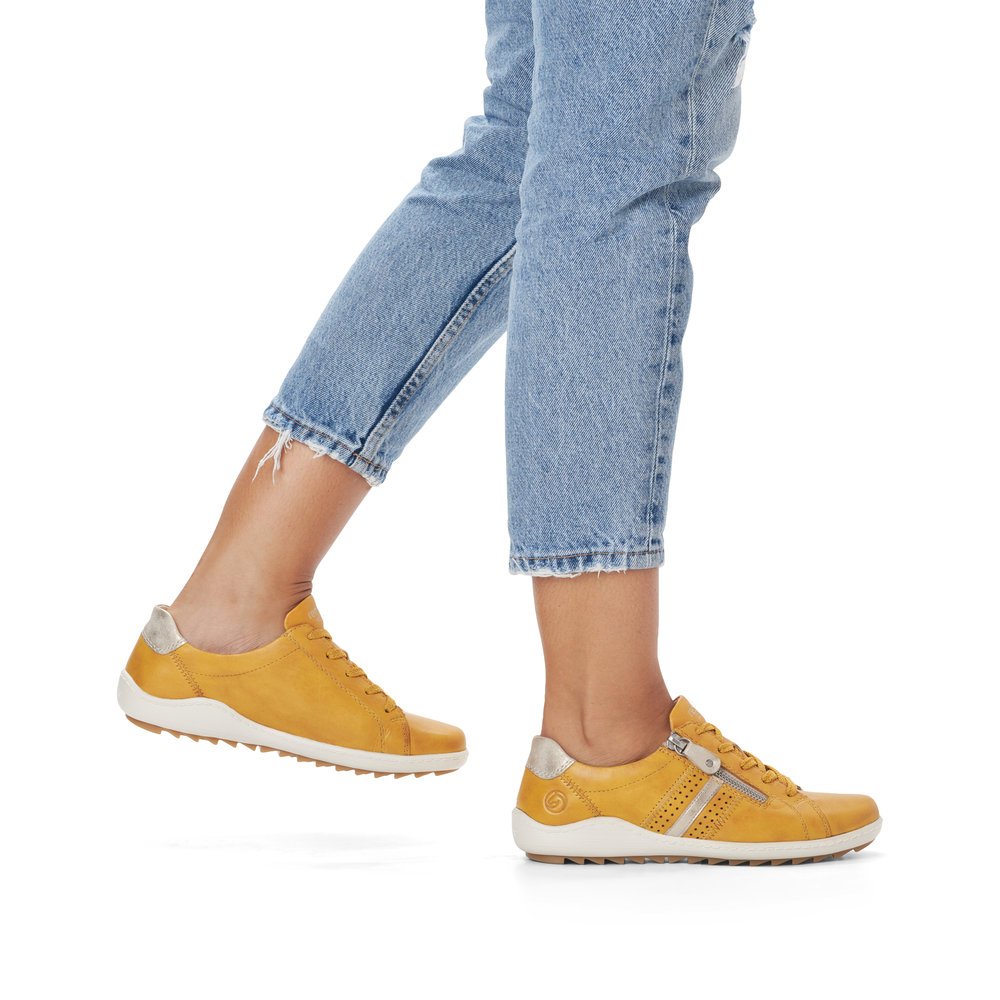Yellow remonte women´s lace-up shoes R1432-68 with a zipper and holes on the side. Shoe on foot.