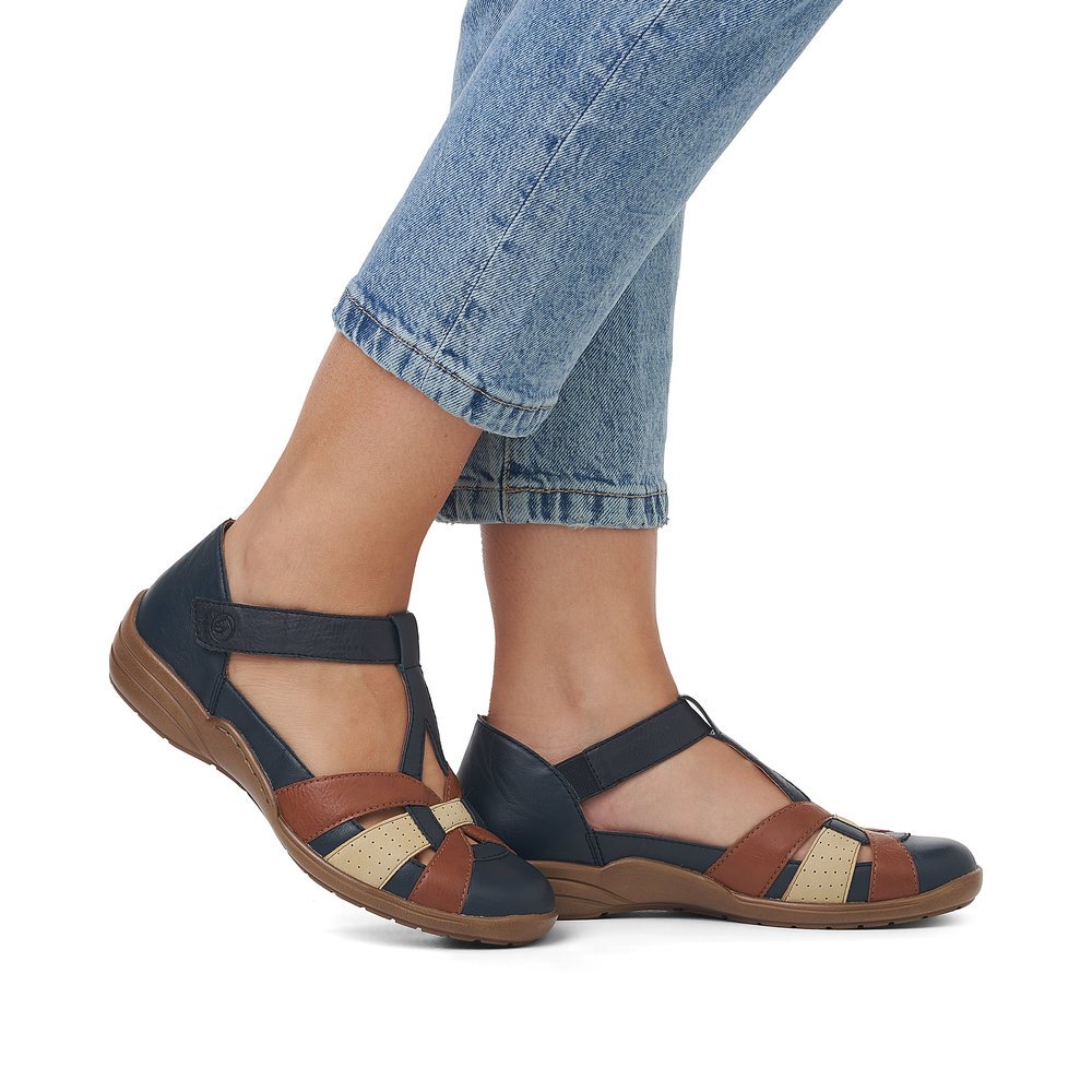 Navy blue remonte women´s strap sandals R7601-14 with a hook and loop fastener. Shoe on foot.