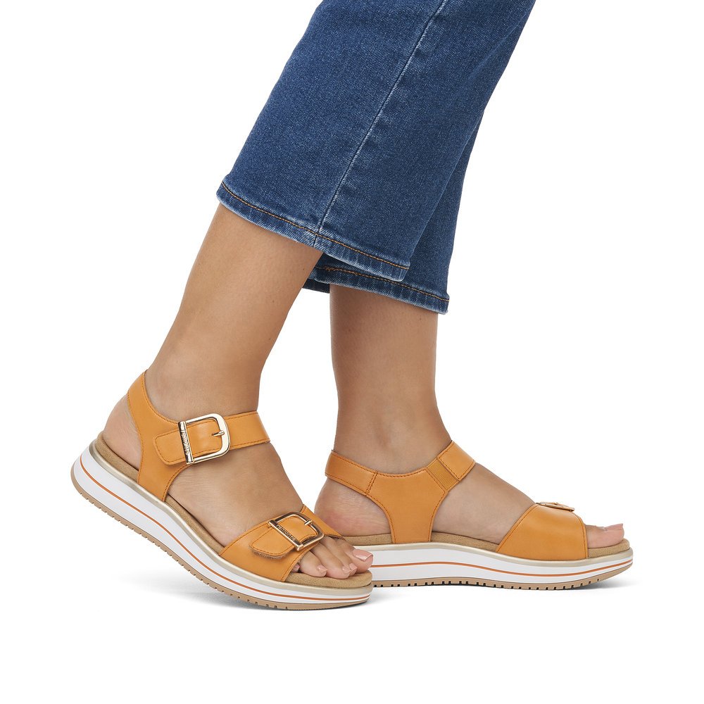Saffron orange remonte women´s strap sandals D1J51-38 with hook and loop fastener. Shoe on foot.