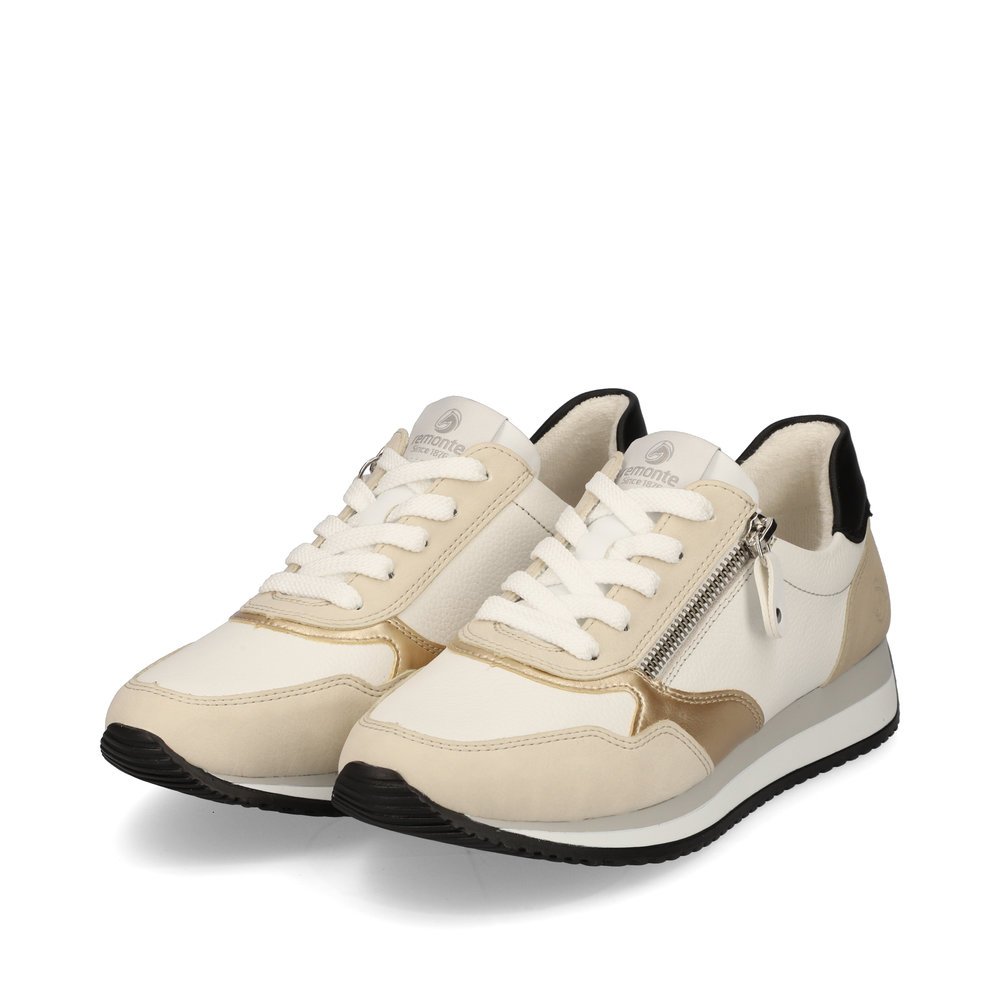 remonte baskets blanches pour femmes D0H01-82 avec une fermeture éclair. Chaussures inclinée sur le côté.