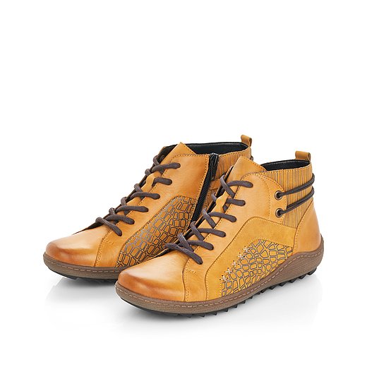 Gelbe Stiefeletten aus Glattleder mit Reißverschluss und Schnürung und Wechselfußbett. Schuhe seitlich schräg. 